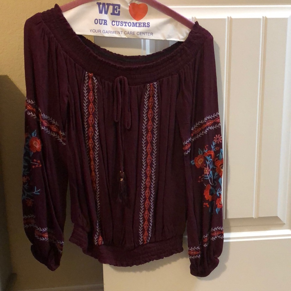 maroon shirt with flower designs